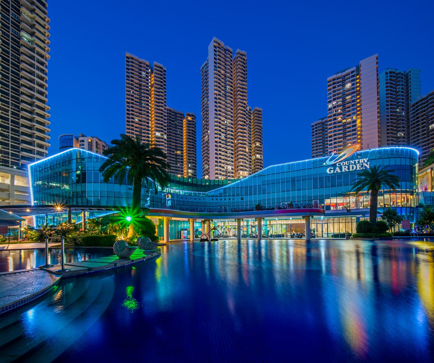 Country Garden Danga Bay night view with illuminated clubhouse and reflection pool, Johor Bahru